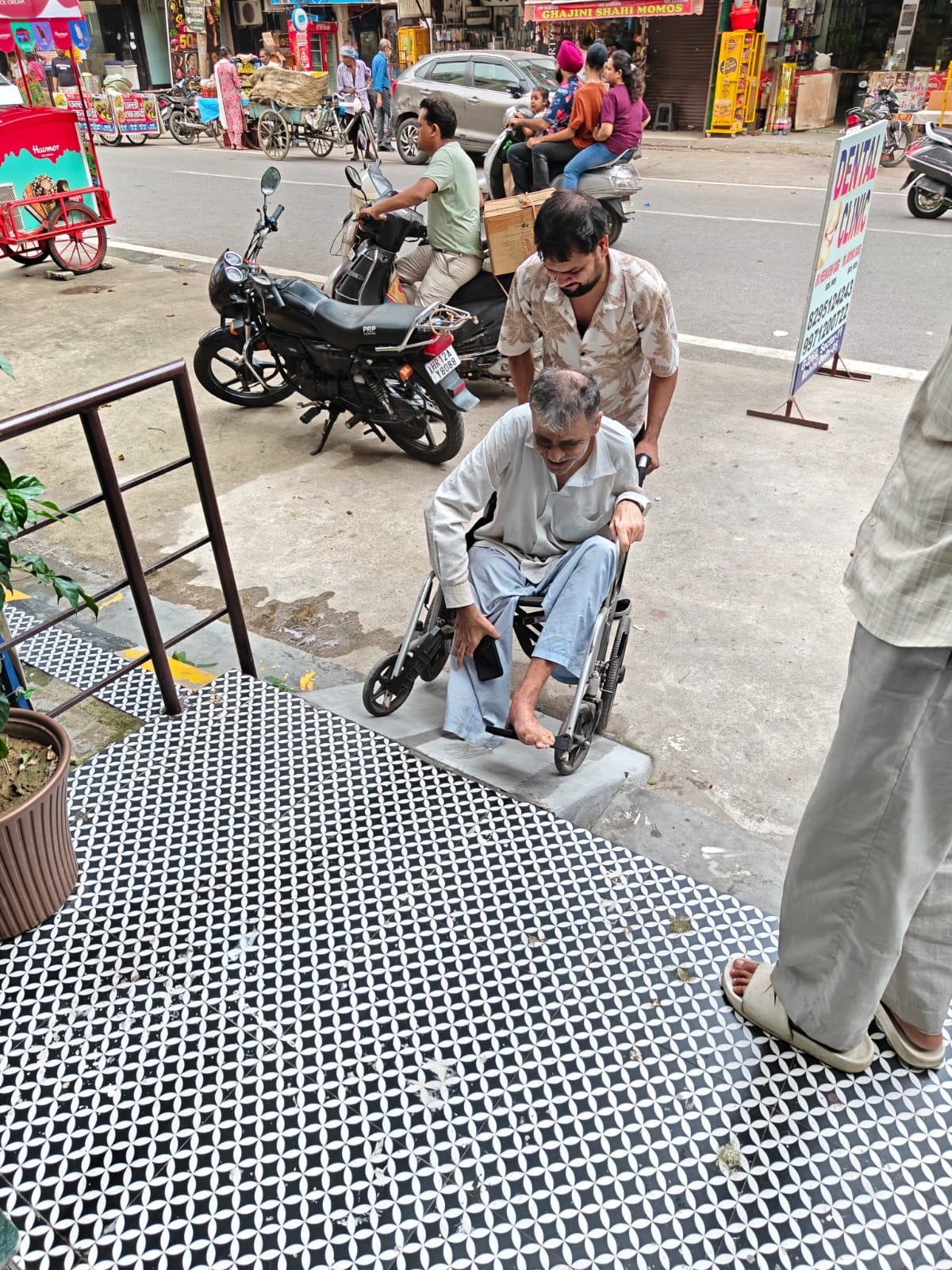 Wheelchair user using the access ramp at the clinic entrance